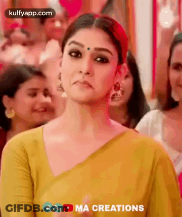 Woman In Yellow Saree Making Funny Face In Crowd GIF