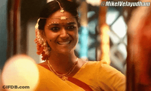 Woman In Yellow Sari Smiling At @Mikelvelayudham Sign GIF