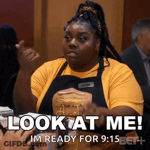 Woman In Yellow Shirt And Black Apron Saying Look At Me GIF