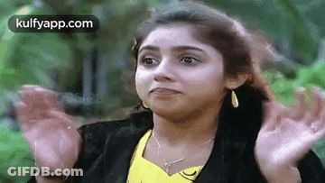 Woman In Yellow Shirt And Black Jacket Making Funny Face GIF