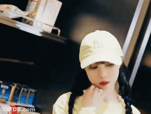 Woman In Yellow Shirt And White Hat With Letter N GIF