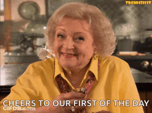 Woman In Yellow Shirt Cheers Whiskey First Of The Day GIF