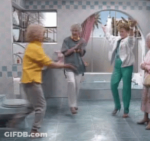 Woman In Yellow Shirt Dancing In Bathroom With Others GIF