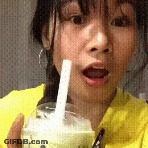 Woman In Yellow Shirt Drinking With Straw GIF