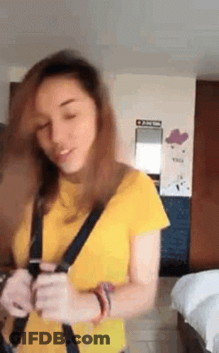 Woman In Yellow Shirt Holding Cell Phone GIF