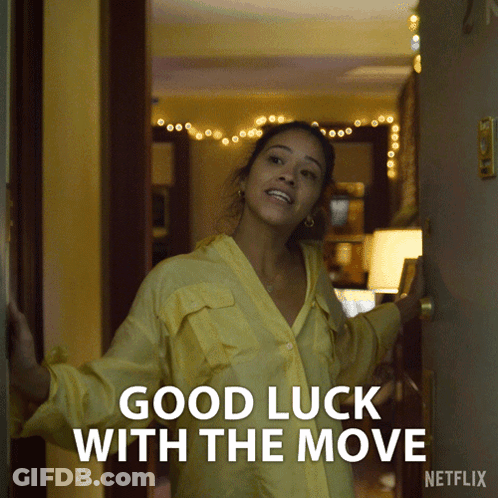 Woman In Yellow Shirt In Front Of Good Luck With The Move Door GIF