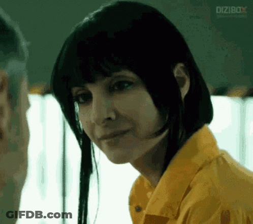 Woman In Yellow Shirt Looks At Man In Prison GIF