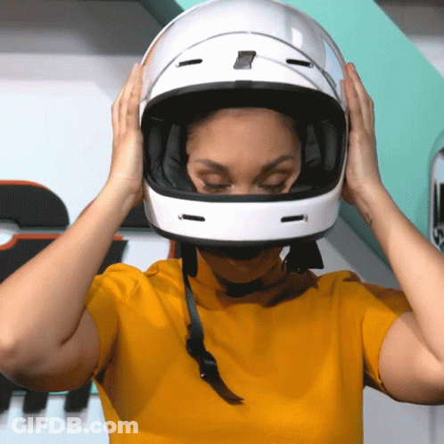 Woman In Yellow Shirt Putting On Helmet GIF