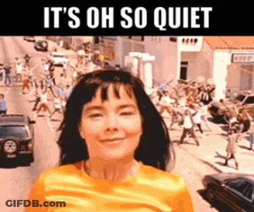 Woman In Yellow Shirt Screaming While People Dance GIF