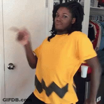 Woman In Yellow Shirt Standing By Closet GIF