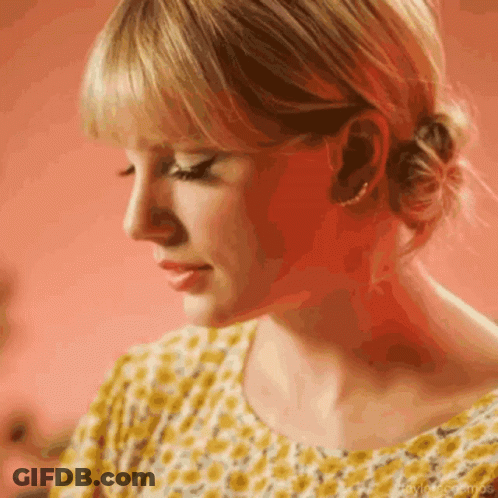 Woman In Yellow Shirt With Bun GIF