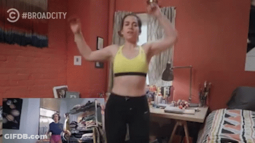 Woman In Yellow Sports Bra Dancing In Bedroom With Broad City Logo GIF