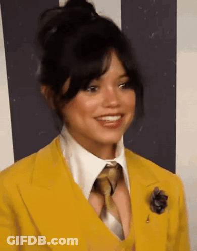 Woman In Yellow Suit And Tie Smiling GIF