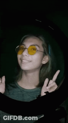Woman In Yellow Sunglasses Giving Peace Sign GIF