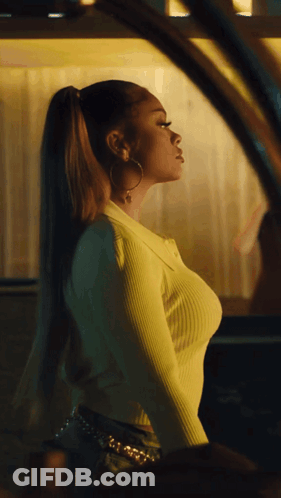 Woman In Yellow Sweater And Hoop Earrings At Car Window GIF