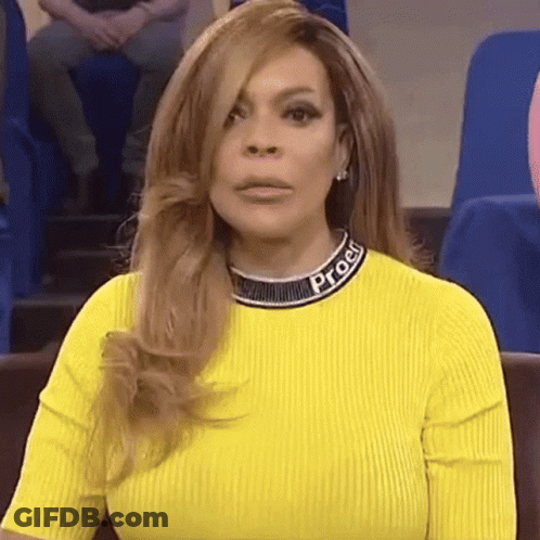 Woman In Yellow Sweater And Necklace Sitting GIF