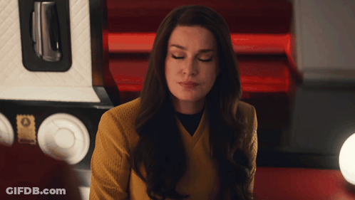 Woman In Yellow Sweater Looking Down GIF
