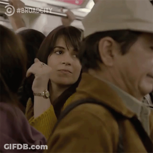 Woman In Yellow Sweater On Train GIF