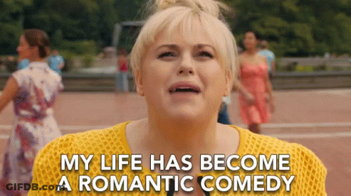 Woman In Yellow Sweater Saying My Life Has Become A Romantic Comedy GIF