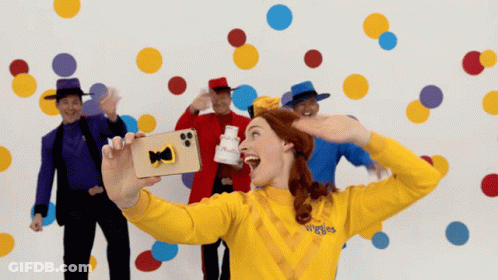 Woman In Yellow Sweater Saying Wiggles GIF