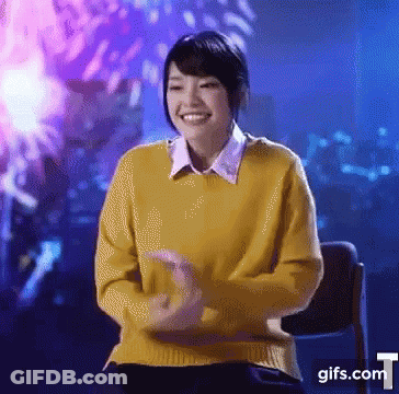 Woman In Yellow Sweater Smiling At Fireworks GIF