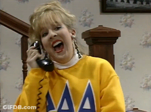 Woman In Yellow Sweater Talking On Phone GIF