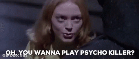 Woman In Yellow Sweater Talking To Man In Black Shirt GIF