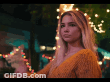 Woman In Yellow Sweater With Lights GIF