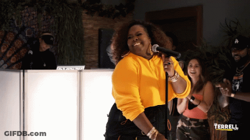 Woman In Yellow Sweatshirt Singing GIF