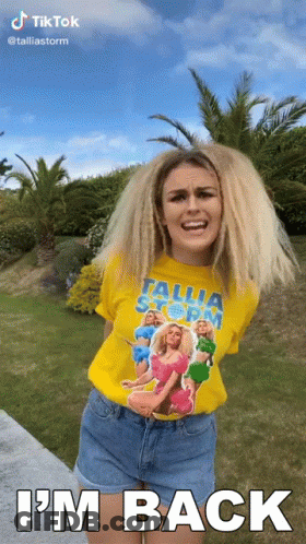 Woman In Yellow Tallia Storm T-Shirt Says I'm Back GIF