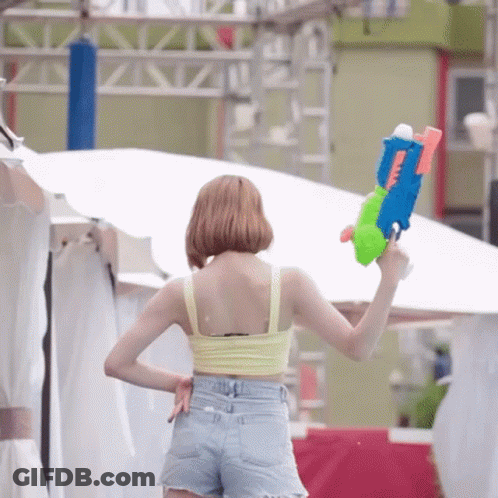 Woman In Yellow Tank Top Holding Water Gun GIF