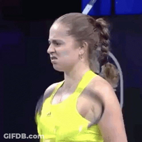 Woman In Yellow Tank Top Making Funny Face With Tennis Racquet GIF