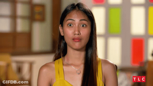 Woman In Yellow Tank Top With TLC Logo GIF