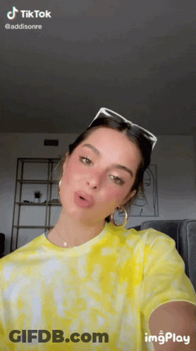 Woman In Yellow Tie Dye Shirt Taking Selfie With Sunglasses GIF