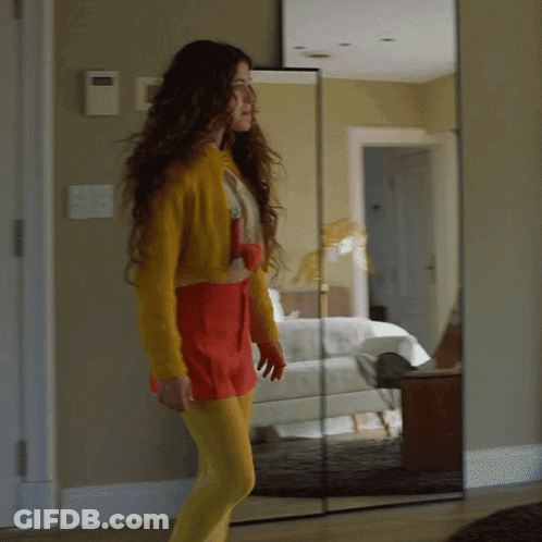 Woman In Yellow Tights In Front Of Mirror GIF