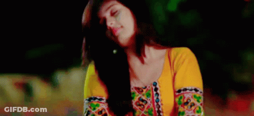 Woman In Yellow Top And Earrings Looking Up At Sky GIF