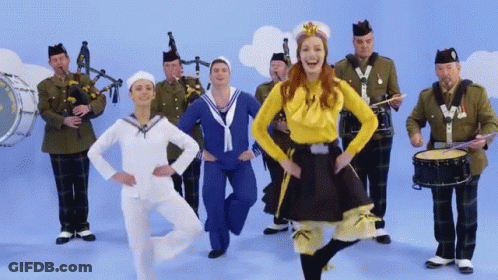 Woman In Yellow Top Dancing With Band GIF