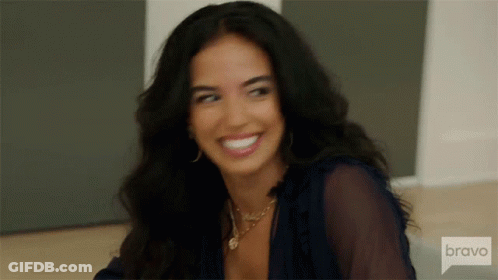 Woman In Yellow Top Sitting In Chair Saying Bravo GIF