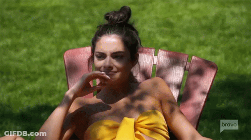 Woman In Yellow Top Sitting In Chair Saying Bravo GIF