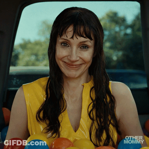Woman In Yellow Top Smiling In Car With Other Mommy GIF