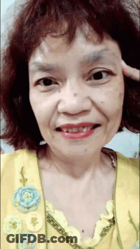 Woman In Yellow Top With Blue Flowers GIF