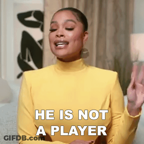 Woman In Yellow Turtleneck Saying He Is Not A Player GIF