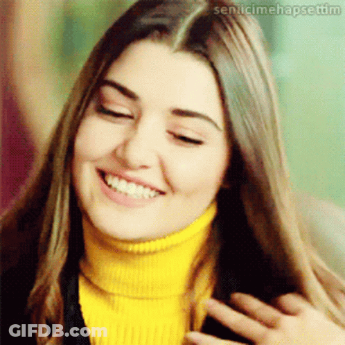 Woman In Yellow Turtleneck Smiling With Sen.icimehapsetim GIF