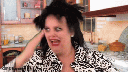 Woman In Zebra Print Making Funny Face In Kitchen GIF