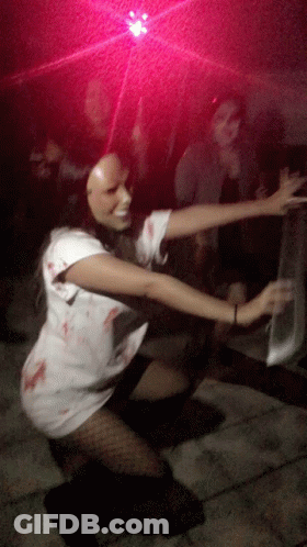 Woman In Zombie Costume Kneeling GIF