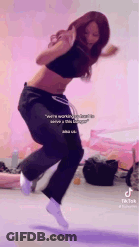 Woman Jumping In Black Crop Top And Sweatpants GIF