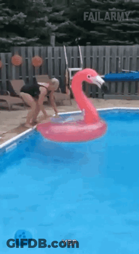 Woman Jumping Into Pool With Flamingo Float GIF
