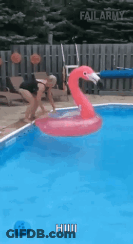 Woman Jumping Into Pool With Inflatable Flamingo GIF