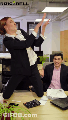 Woman Jumping Man At Desk With Calculator And Papers GIF