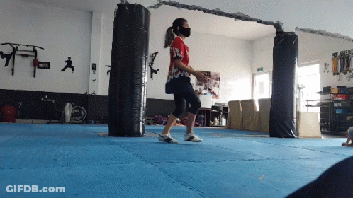 Woman Jumping On Blue Gym Mat GIF